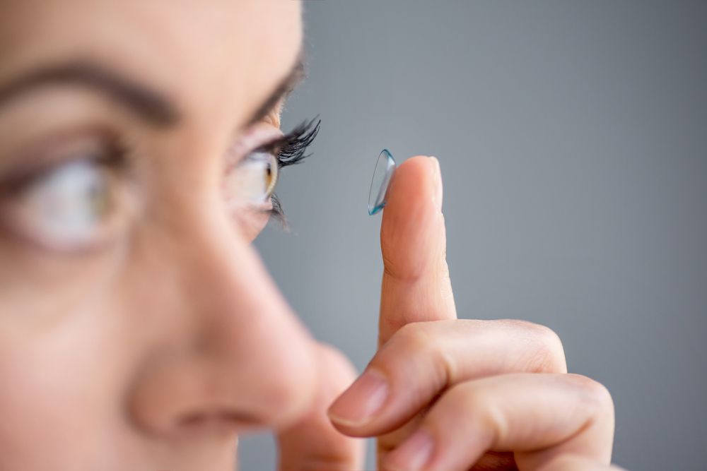 Woman putting on a contact lens
